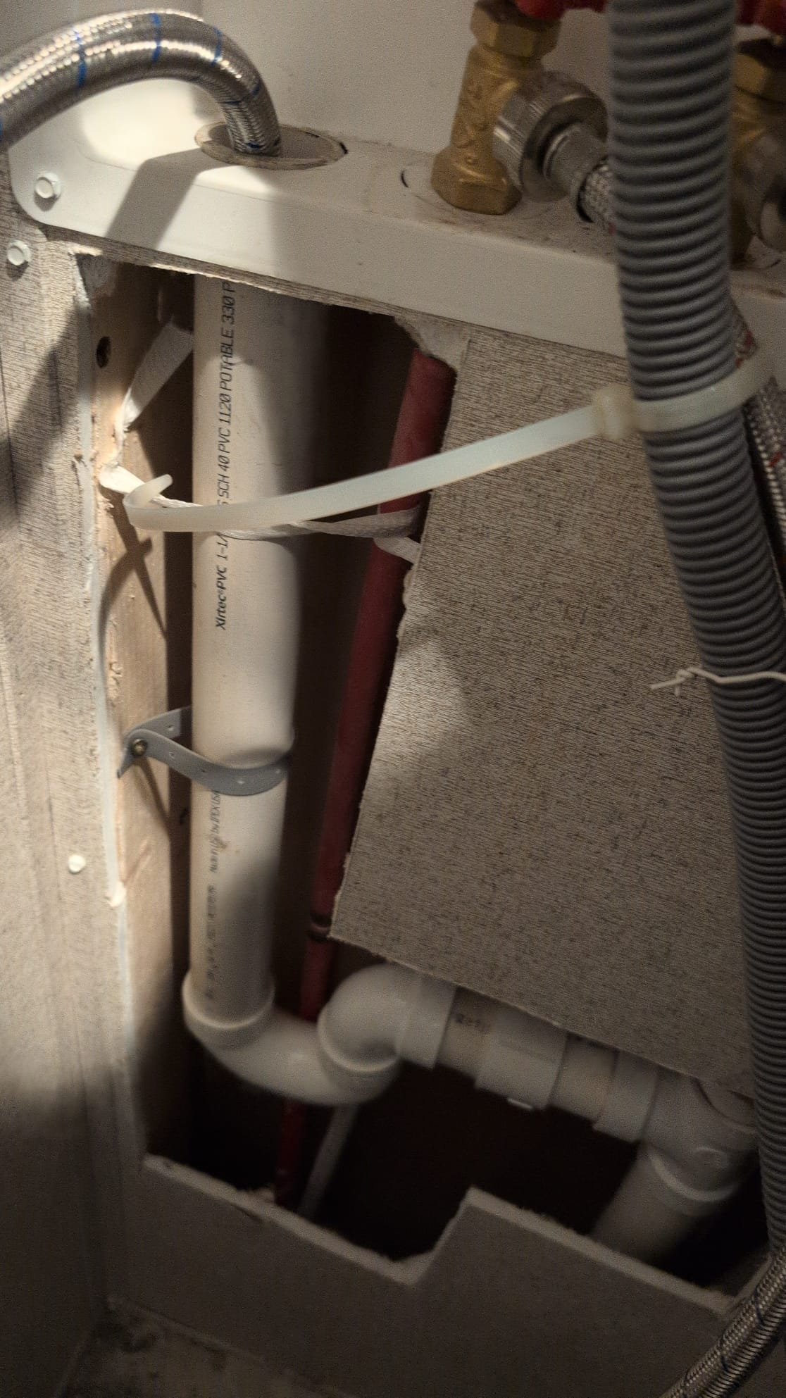 The client contacted us due to recurring water issues after using their washing machine. I inspected the previous work, which included a coupling and a p-trap connected to the washer box. I tested the cold inlet flex line at full blast and observed for leaks, finding none from the p-trap or the areas we had worked on. However, I noticed the discharge line to the washing machine was inadequately secured, likely moving during water discharge. I concluded that the discharge tube's movement caused the water to spray. I securely strapped the discharge line to prevent future movement, ensuring the issue is resolved.