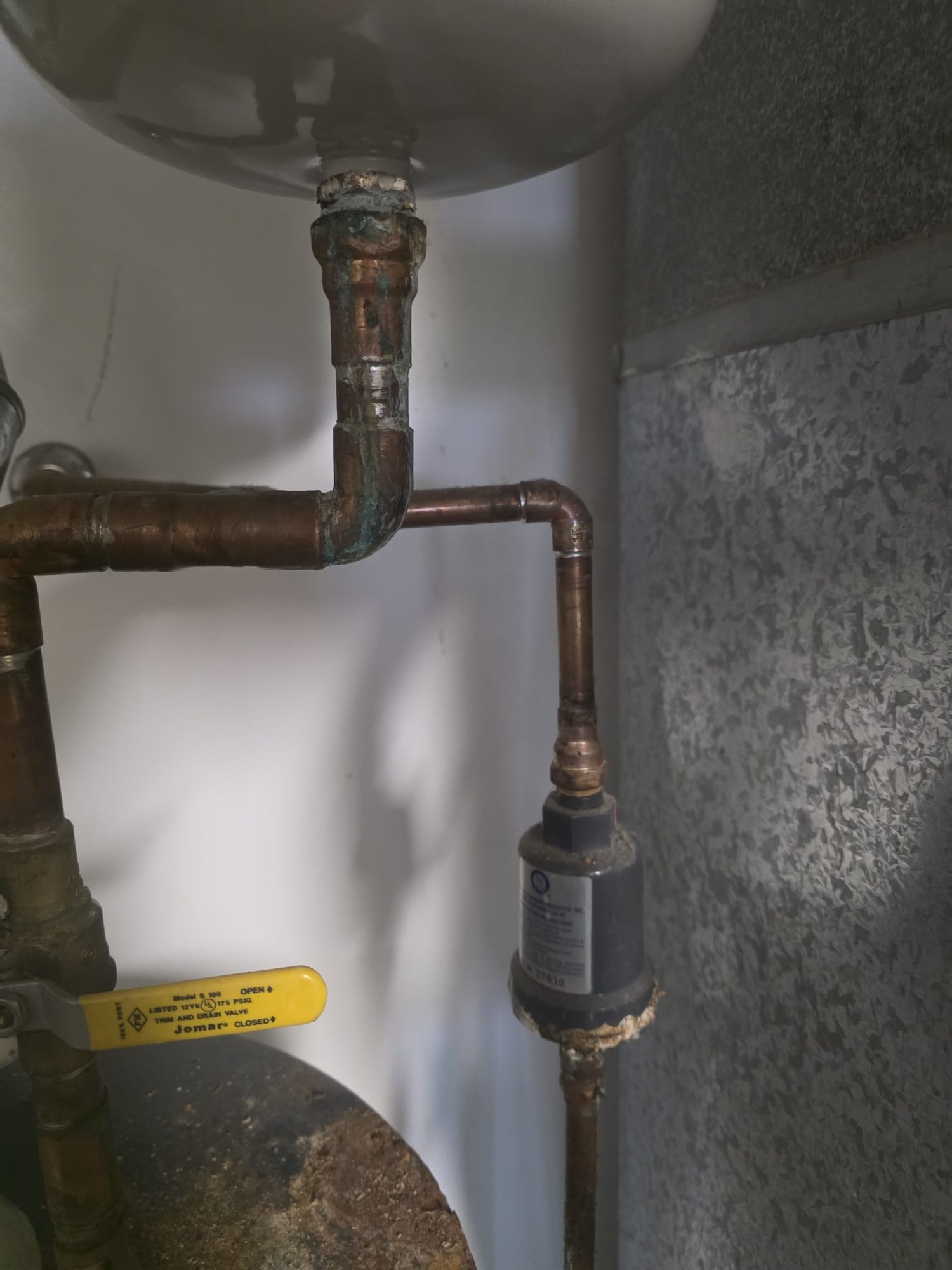 Upon arrival, I conducted a thorough inspection of the water heater, which was over 20 years old. The age and condition of the unit indicated it was time for a replacement. Additionally, I identified a small leak originating from the body of the trap primer. I explained these findings to the homeowner, emphasizing the importance of replacing the water heater to prevent potential future issues and ensuring the system operates efficiently. I also detailed the necessity of addressing the leak to avoid any water damage. A crew has been scheduled to perform the replacement and repair this afternoon.