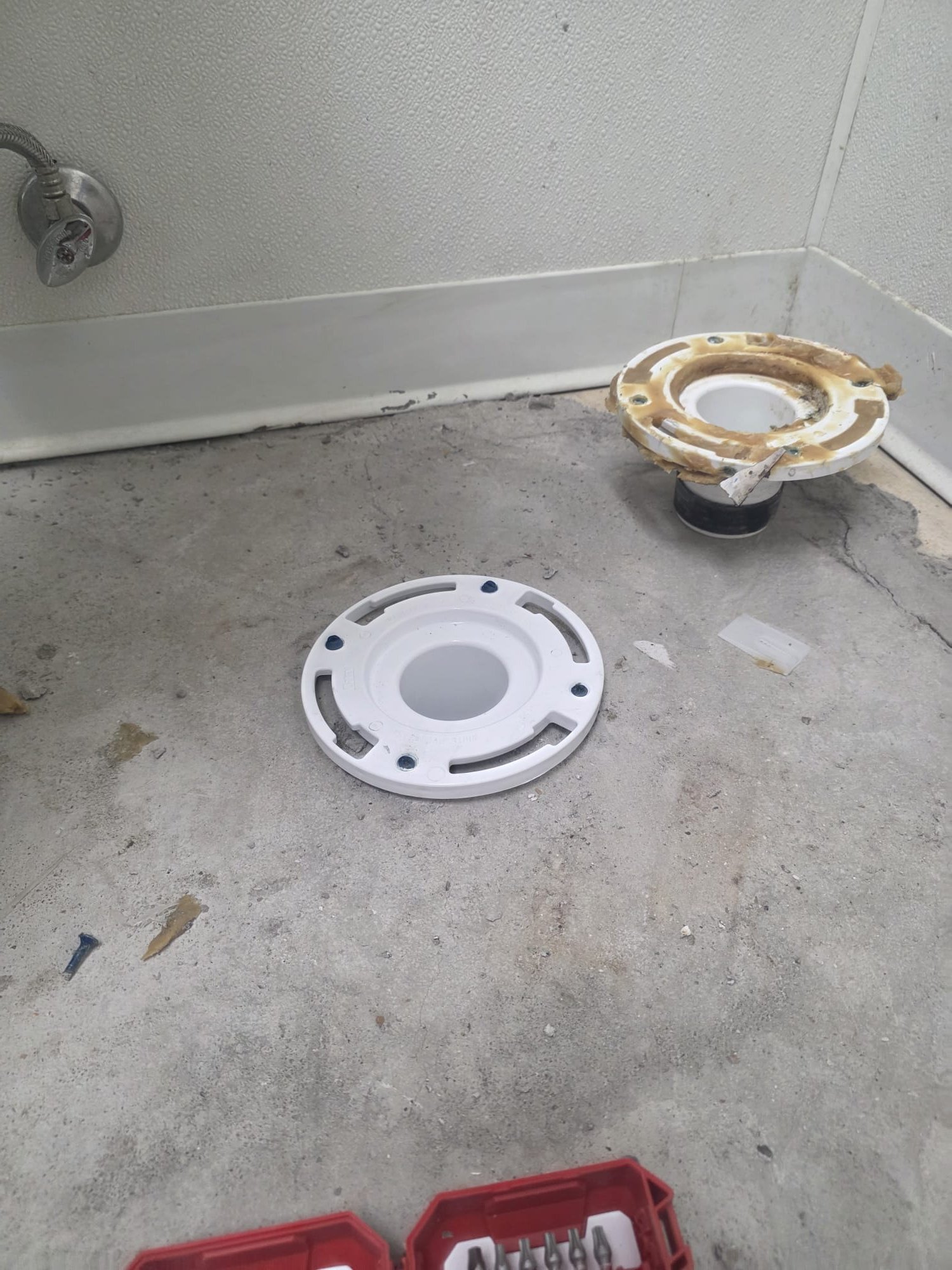 The job involved removing a broken plastic flange and installing a new stainless steel flange, securely bolted to the concrete for durability. Upon removal, I discovered an insert-style flange, necessitating a switch to a PVC flange. The floor's unevenness required shimming the toilet for stability, and I applied silicone to seal the base. After installation, I tested the toilet for proper operation and leaks, ensuring all components functioned correctly. The work was completed to guarantee solid support and optimal performance of the toilet.