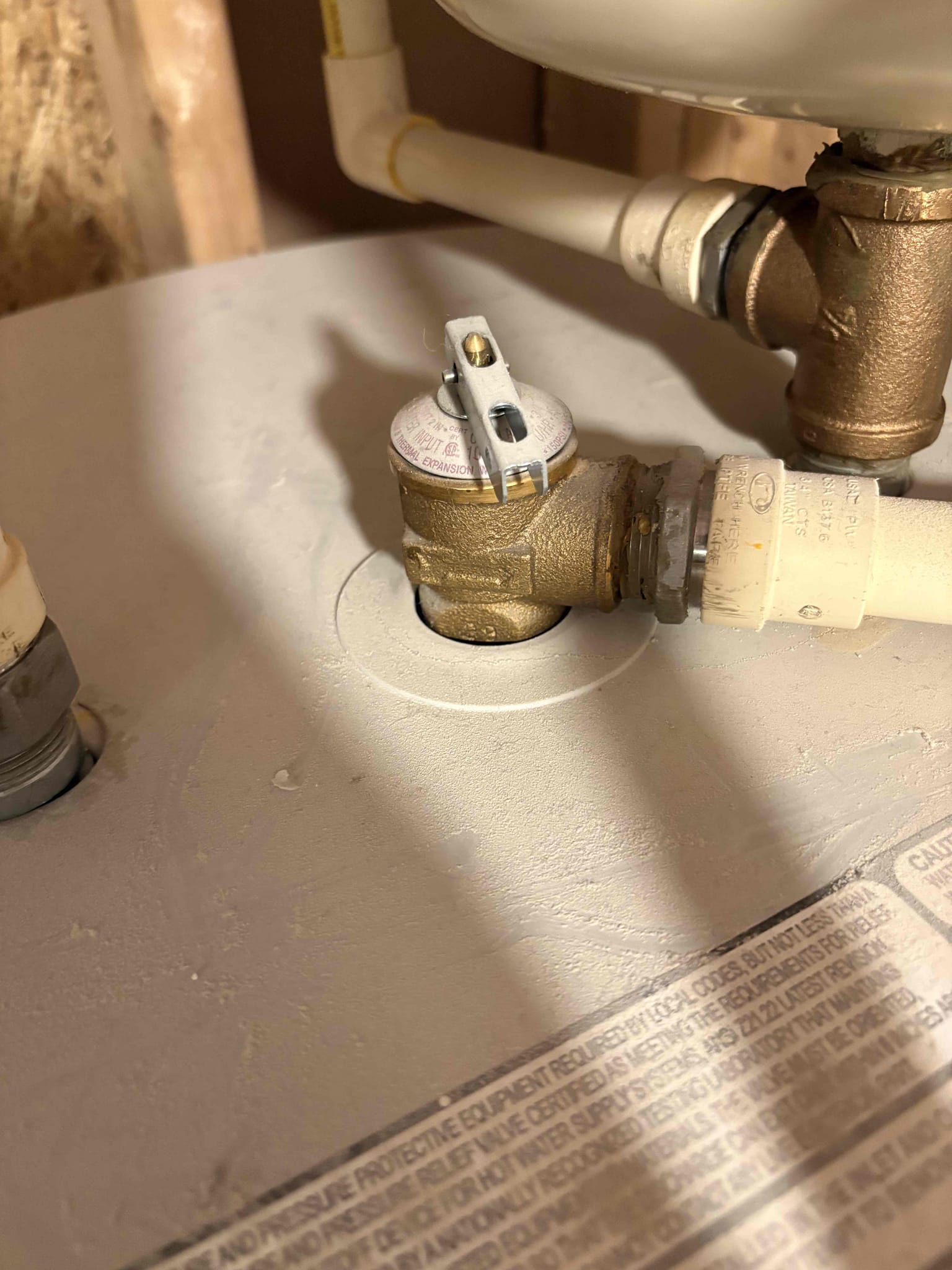 I conducted a thorough plumbing maintenance check after being informed about insufficient hot water. I began by inspecting the water heater tank's operation. After flushing out sediment, I assessed the expansion tank by pressing the shrader valve. The valve released water, indicating a ruptured bladder. I explained to the customer that a faulty expansion tank can lead to uneven heating and excessive pressure on the water pipes, necessitating its replacement.