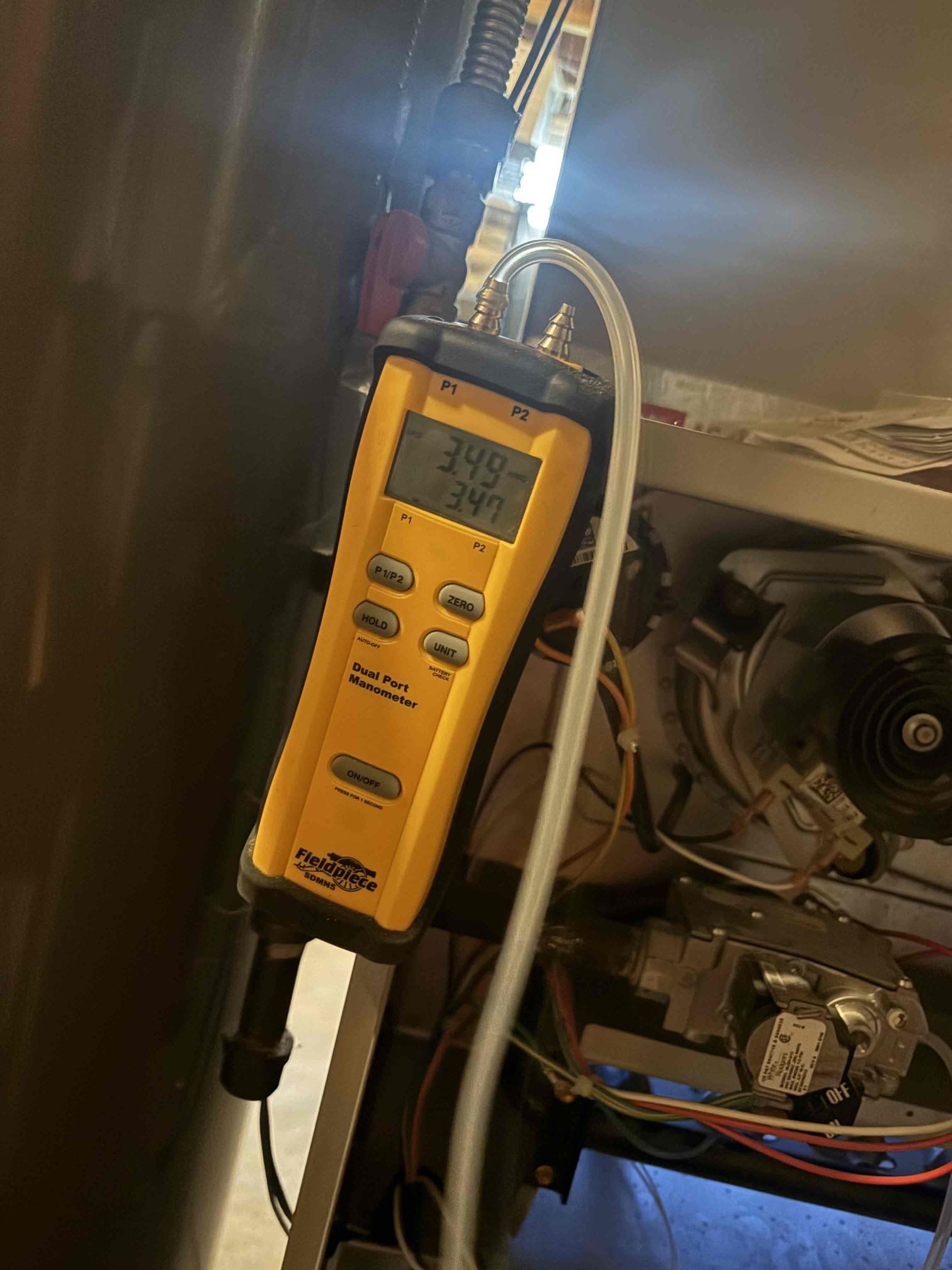 New Albany, OH - During the service, I replaced the previously diagnosed faulty circuit board. After installation, I tested the heating operation and detected excessively high PPM readings in the flue. I checked the gas pressure, which was at 5.7" WC, and adjusted it to the proper setting. Despite this adjustment, the flue PPM readings remained elevated. Further testing showed the inducer motor was drawing 2.2 amps, exceeding its rated amperage of 1.52 amps. I recommended replacing the inducer motor, but the customer declined for now. I also tested the cooling operation and found the circuit board fuse had blown. I diagnosed a faulty contactor coil and thermostat, likely related to the circuit board short, and replaced the contactor. The customer plans to order a replacement thermostat faceplate. The heating system still shows high flue PPM readings, and the inducer motor operates above its rated amperage, suggesting further repairs are needed.