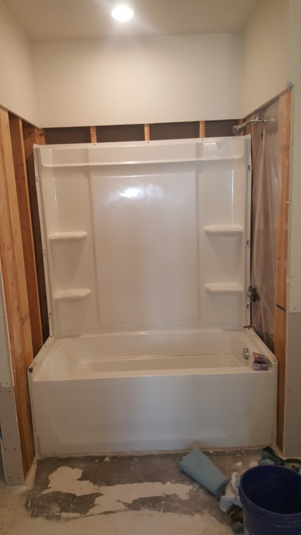 Installing 2 fiberglass tubs with walls for condominiums.  West Jordan 