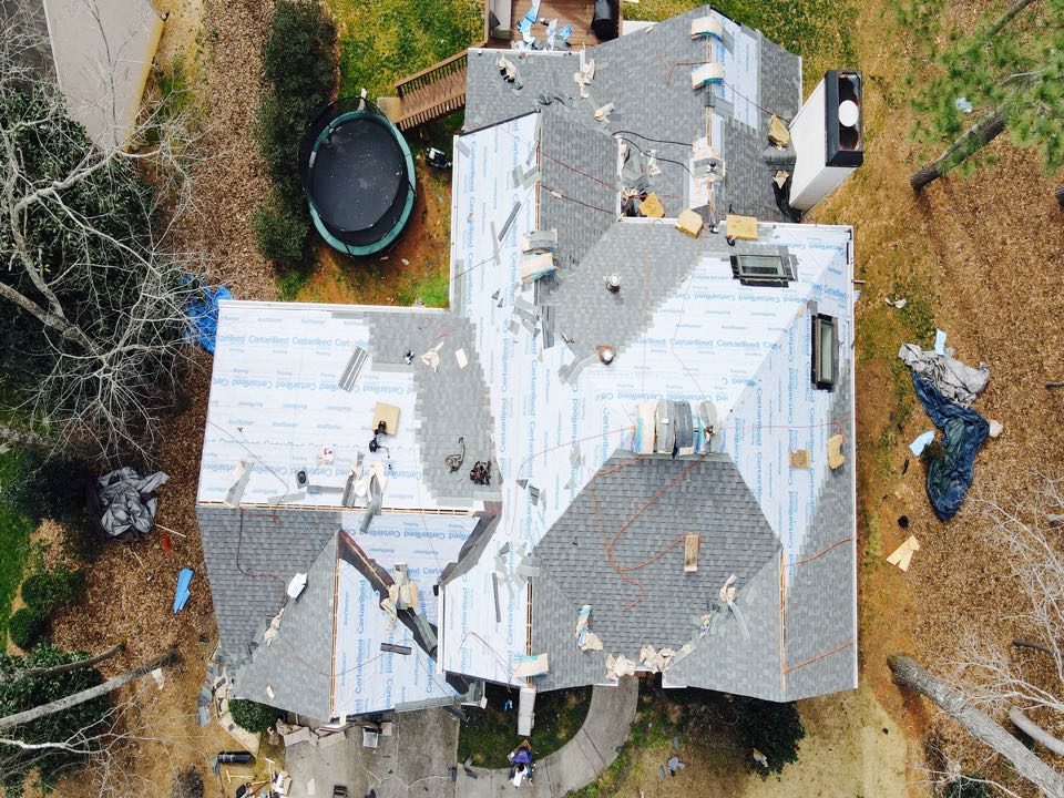 Woodstock, GA - New roof installation going up in Eagle Watch! This 2934 sq ft roof was replaced through the customer’s insurance due to hail and wind damage. We have had many clients in this area because of recent storms. You may qualify for a new roof due to these circumstances! This roof is being put up with the finest Certainteed equipment; Driftwood landmark shingles, RoofRunner synthetic felt, shadow ridge, SwiftStart, Filtered ridge vents, drip edge, and wintergaurd. Schedule your free inspection today! Woodstock, GA - New roof installation going up in Eagle Watch! This 2934 sq ft roof was replaced through the customer’s insurance due to hail and wind damage. We have had many clients in this area because of recent storms. You may qualify for a new roof due to these circumstances! This roof is being put up with the finest Certainteed equipment; Driftwood landmark shingles, RoofRunner synthetic felt, shadow ridge, SwiftStart, Filtered ridge vents, drip edge, and wintergaurd. Schedule your free inspection today!