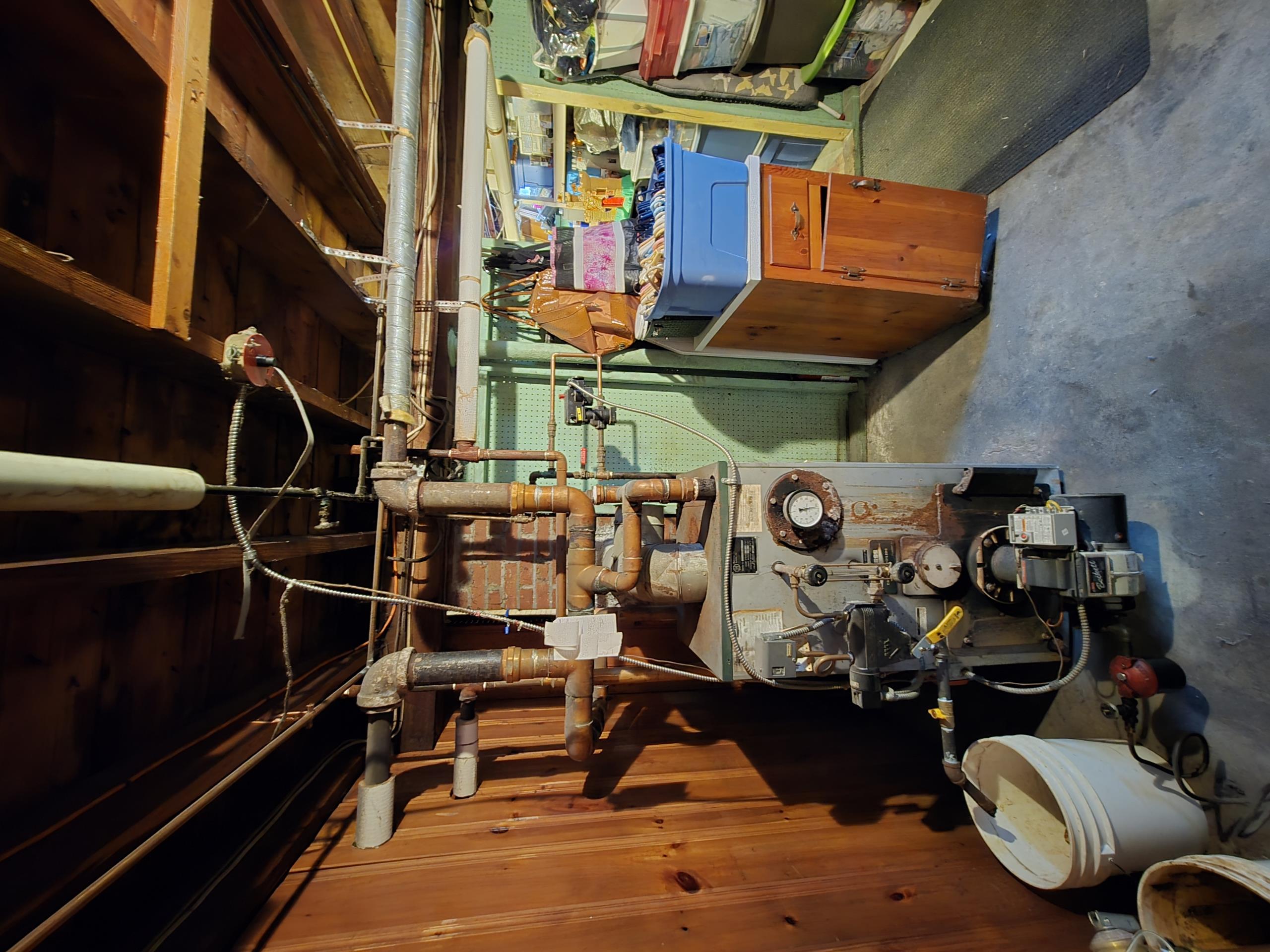 Replacement of the existing Peerless EC-04 oil-fired steam boiler with a new, standard efficiency cast iron steam boiler. The new boiler will be precisely sized based on the calculated 455 sq ft of Equivalent Direct Radiation (EDR) for the home's heating load, ensuring optimal performance and efficiency for your one-pipe steam system.

All existing boiler components, including the immediate surrounding piping, will be replaced to ensure the new system's reliability. The existing cast iron radiators and their thermostatic valves will remain untouched.

The new boiler will utilize the existing chimney for venting, provided that a chimney inspection confirms it is suitable for safe and efficient operation. The existing fresh air intake will be modified to properly serve the new burner.

The existing oil tank will remain in place. A new 40-foot length of coated oil line will be installed from the oil tank to the new boiler, along with a new oil filter.

Due to the absence of a bulkhead, th