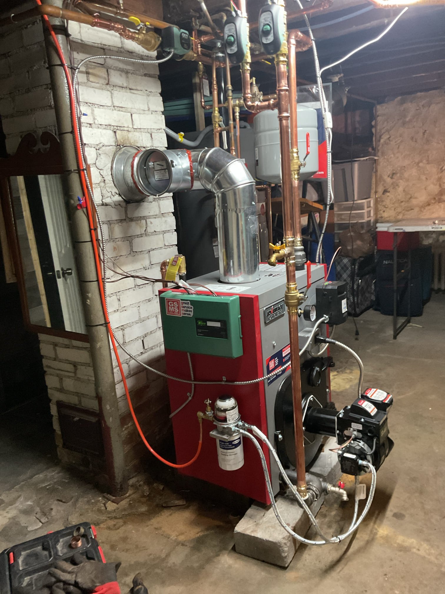 Replacement of the failed cast-iron boiler with a new cast-iron boiler. The new boiler will re-use the existing chimney for venting.

The two-zone setup will remain, with a dedicated circulator for the system and two new zone valves to control each zone. The existing thermostats will remain in place.

A new coated oil line will be installed, as the existing one is unsleeved and buried in the concrete slab. Since the oil line will be vertical, our Tigerloop system will be installed to ensure air-free oil enters into the new boiler.