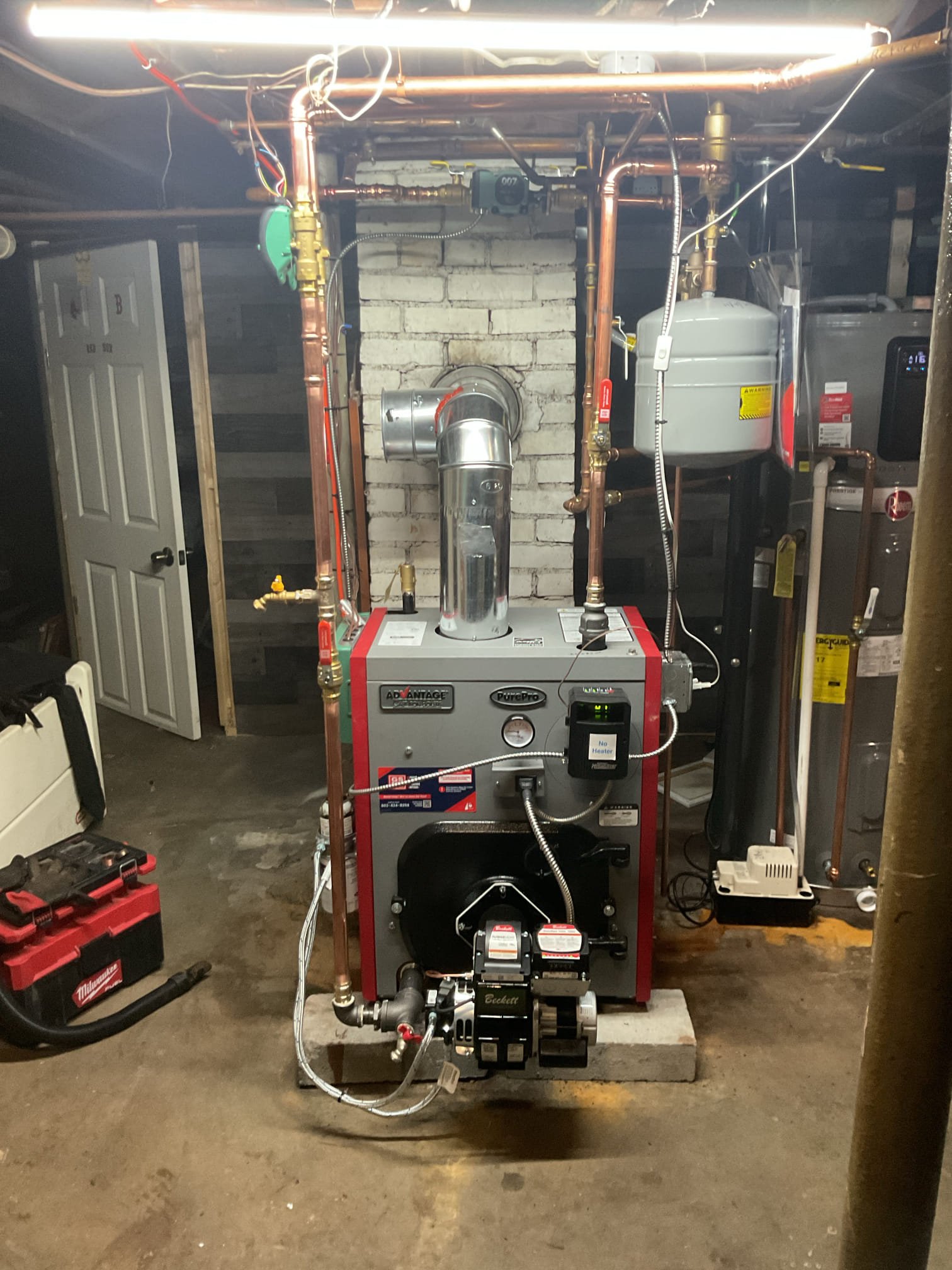 Replacement of the failed cast-iron boiler with a new cast-iron boiler. The new boiler will re-use the existing chimney for venting.

The two-zone setup will remain, with a dedicated circulator for the system and two new zone valves to control each zone. The existing thermostats will remain in place.

A new coated oil line will be installed, as the existing one is unsleeved and buried in the concrete slab. Since the oil line will be vertical, our Tigerloop system will be installed to ensure air-free oil enters into the new boiler.