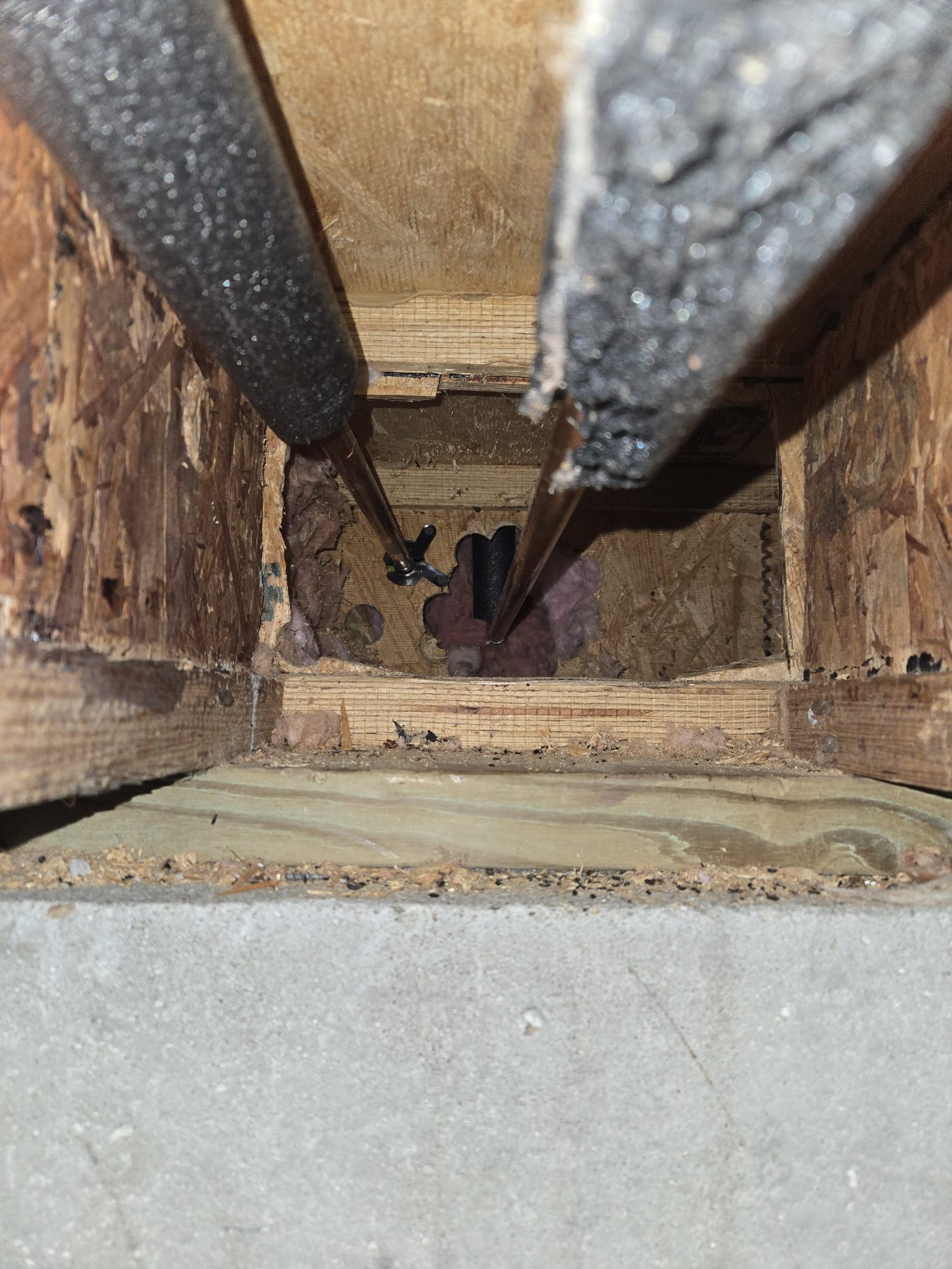 The water pipes that go to the shower valve pass through a floor ontop of a concrete slab. The joist bays are in-fact insulated. I would reccomend putting heat tape on the pipes. I suggest contacting your property management company first. If they will not do it please give us a call. Thank you! 