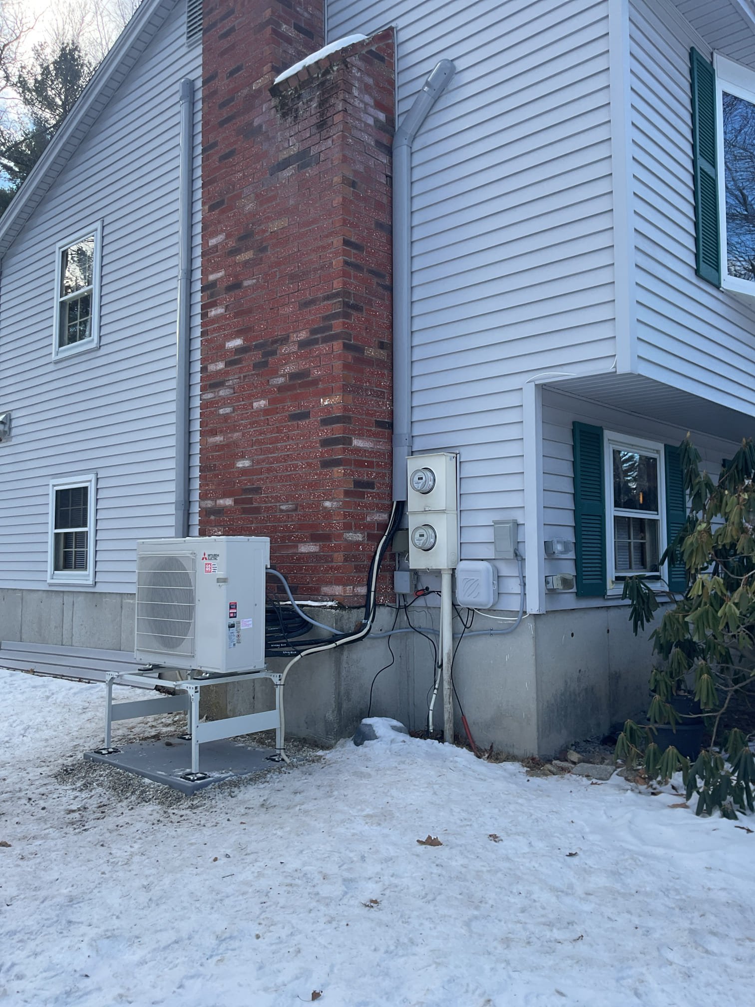 Installation of a three-zone mini-split system to provide cooling and supplemental heating to the living area and the master bedroom.

The outdoor unit will be installed in front of the chimney, positioned to the right of the chimney clean-out, ensuring it does not block the electrical meter. Gray CoverGuard will be used instead of the standard white for a beautiful color match during the installation.

The lineset for the living room unit will run up along the edge of the chimney and against the home. From there, the lines will run up through the attic and over to the other gable end of the home to connect into the master bedroom unit. The CoverGuard will run down the exterior of the home and terminate right above the garage door, where the condensate will drain out onto the driveway.

The lines for the third unit in the basement will run over to the unit location.

The electrical circuit will be added to the existing system. Please note: Electrical pricing is based on not needing to 