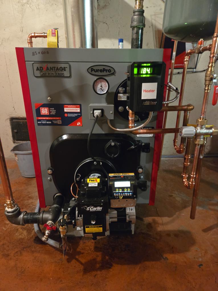 Scope of Work:
Replacement of the existing oil-fired boiler with a new, reliable Cast Iron Oil Boiler featuring an internal tankless coil for domestic hot water.

Hydronic Piping Upgrade (GSMS Standard):

Circulator Conversion: We will remove the existing system of zone valves and a single pump. The system will be repiped to feature dedicated circulator pumps for each of the two heating zones. This upgrade provides better flow, redundancy, and reliability.

Near-Boiler Piping: Installation includes our complete piping package: new isolation flanges, high-performance air eliminator, expansion tank, automatic feed valve, and backflow preventer.

Domestic Hot Water:

The new boiler will include an internal Tankless Coil to generate domestic hot water, maintaining the same style of operation as the current system.

Venting & burner:

A new high-efficiency oil burner will be set up and calibrated.

The boiler will be connected to the existing chimney flue.