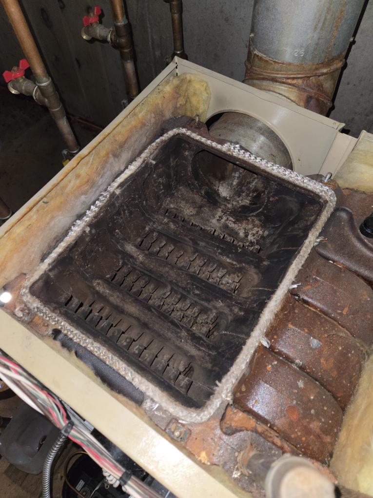 Completed the oil boiler maintenance today. I started off with replacing the oil filter, the pump strainer and gasket and the nozzle. I checked all the boiler accessories and everything looked good other than the auto fill valve is leaking from the threaded connection. I brushed and vacuumed out the heat exchanger. I noticed that the boilers PSI was set pretty high so I drained it down and set the boiler PSI to 13. Lastly I ran the boiler and performed a smoke test and got zero smoke. I performed a combustion analyzer test, this checks the units CO, CO2 and oxygen levels. The boiler was running great. As the boiler started to heat up I noticed that there was water leaking under it. The client wanted to leave it for now and keep an eye on it. The indirect water tank has been leaking for a little bit. We will send over an estimate to replace it. I let the client know that we need to do a water test since she has no water treatment. She said that she was going to do the water test and sen