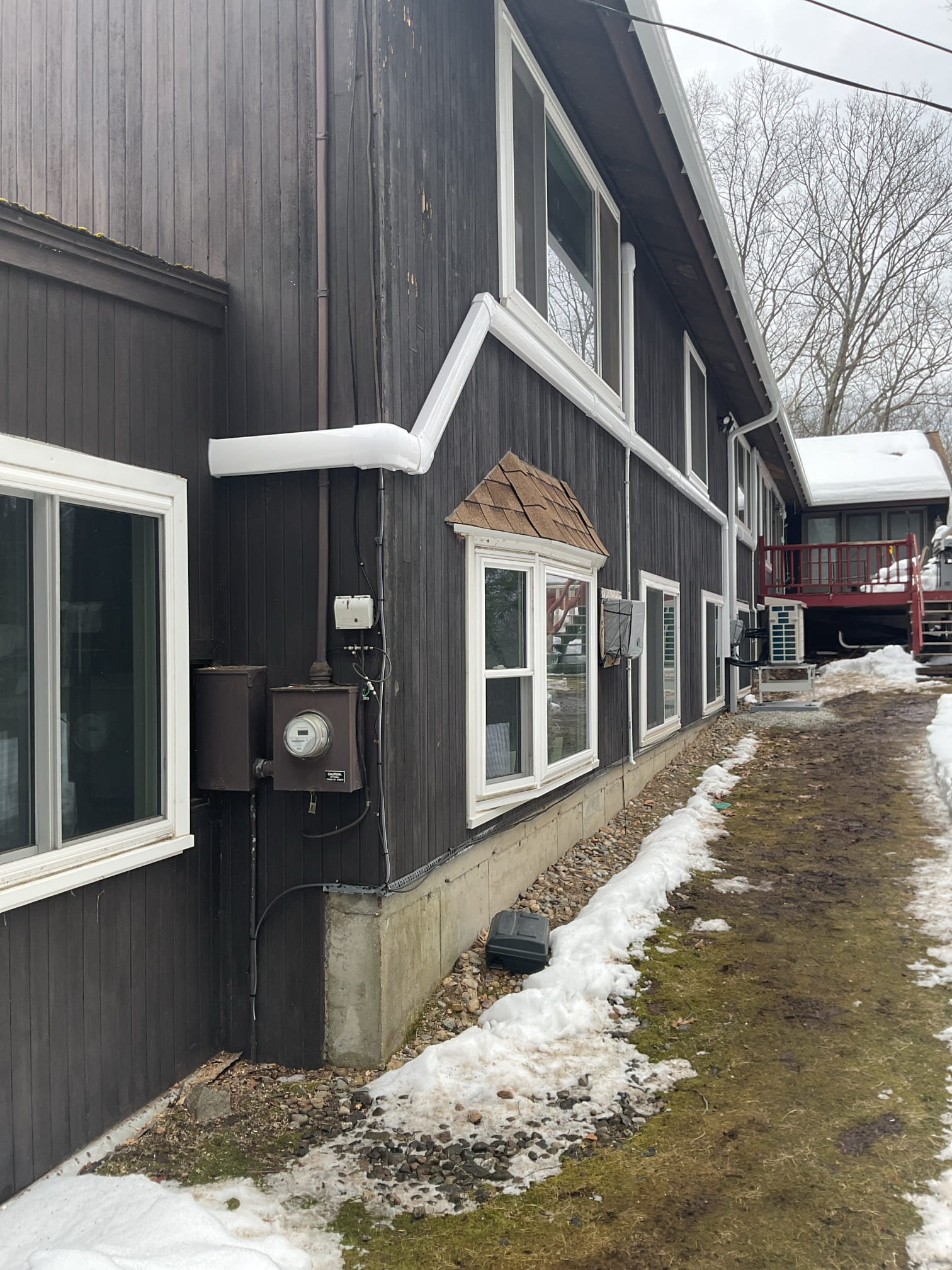 Installation of a multi-zone mini-split system to provide the main house with priority cooling.

Note on Heating: This system is sized and designed primarily for the cooling load. While it will provide supplemental heating during shoulder seasons, it is not designed to provide the total heating load for the home during winter.

System Overview
A multi-zone outdoor unit will be placed in a central location on the back side of the home. This system is sized to handle the current load with enough remaining capacity to add an additional 6,000 BTU head for the second bedroom in the future (a great selling feature).

Indoor Unit Locations & Routing
TV Room / Kitchen: The indoor unit will be installed to the left of the slider. The lineset will run down through the deck into the unfinished basement, run across, and penetrate out to the outdoor unit. This ensures a clean finish and allows a future contractor to easily refinish the deck around the lineset.

Great Room / Living Area: The unit wi