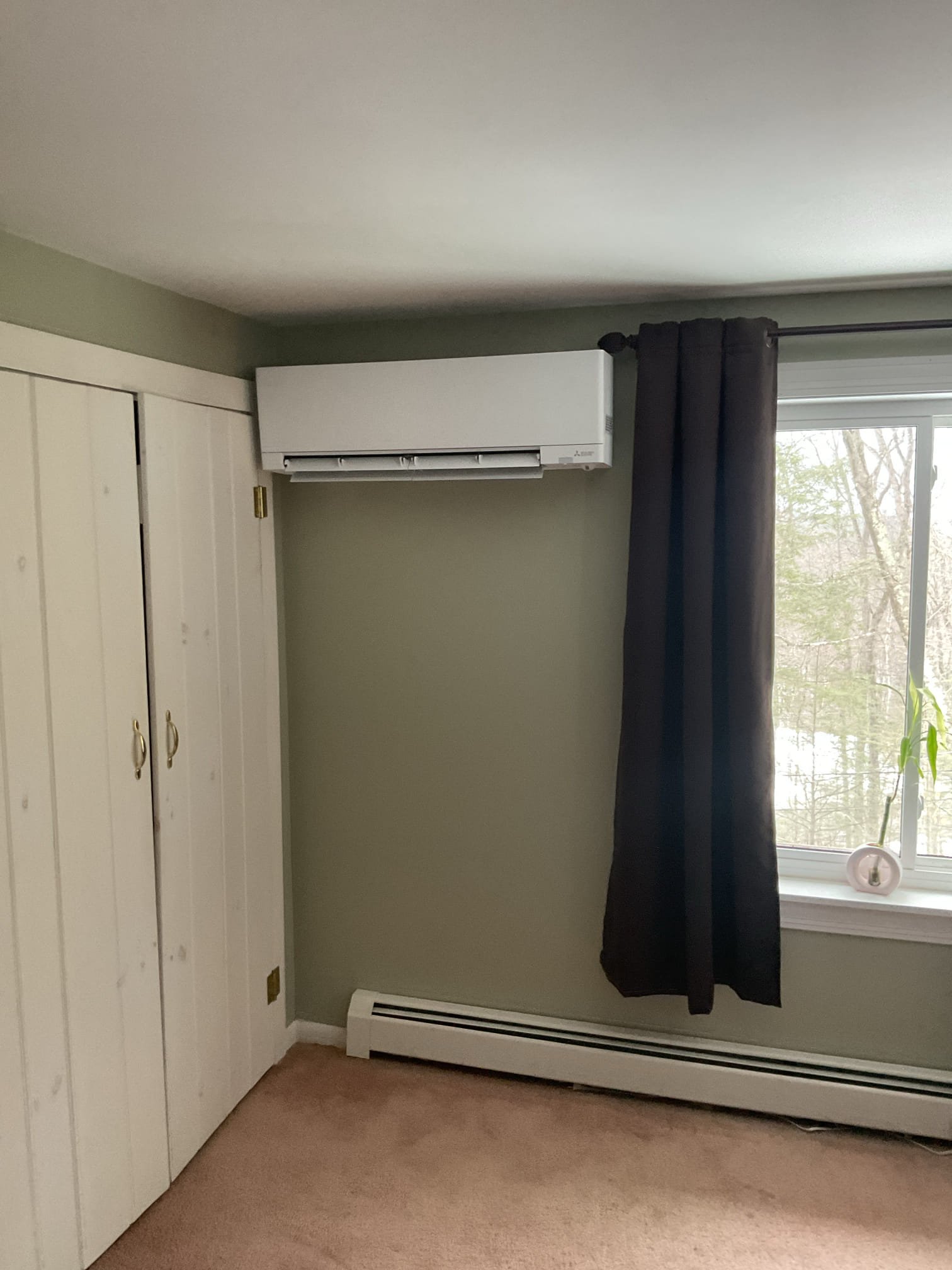 Installation of a multi-zone mini-split system to provide the main house with priority cooling.

Note on Heating: This system is sized and designed primarily for the cooling load. While it will provide supplemental heating during shoulder seasons, it is not designed to provide the total heating load for the home during winter.

System Overview
A multi-zone outdoor unit will be placed in a central location on the back side of the home. This system is sized to handle the current load with enough remaining capacity to add an additional 6,000 BTU head for the second bedroom in the future (a great selling feature).

Indoor Unit Locations & Routing
TV Room / Kitchen: The indoor unit will be installed to the left of the slider. The lineset will run down through the deck into the unfinished basement, run across, and penetrate out to the outdoor unit. This ensures a clean finish and allows a future contractor to easily refinish the deck around the lineset.

Great Room / Living Area: The unit wi