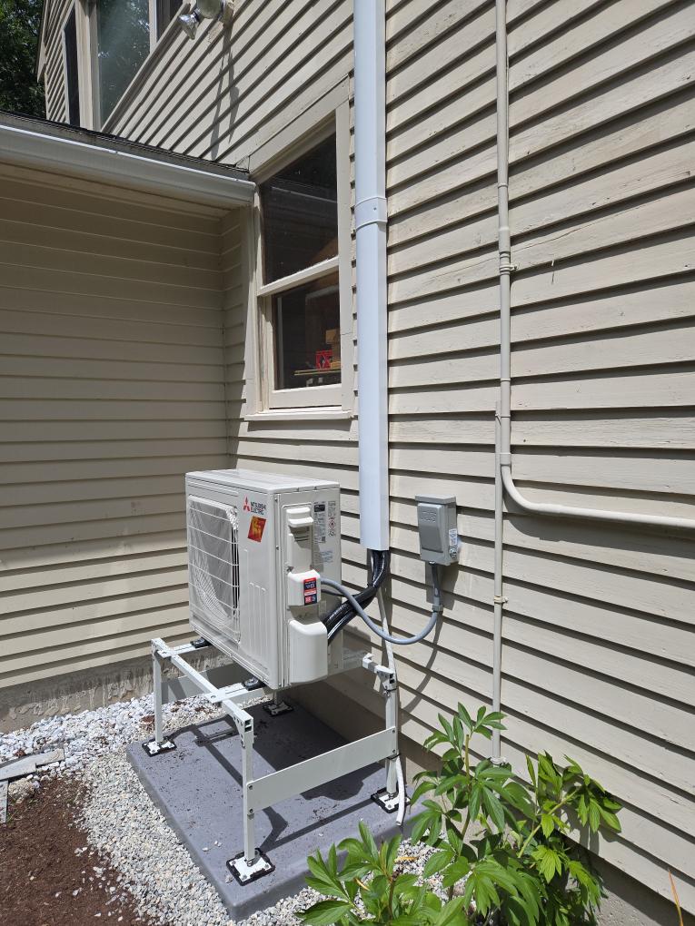 This option is designed to bring dedicated, high-efficiency comfort specifically to the second-floor Main Bedroom. We are proposing a Mitsubishi Single-Zone heat pump system. While this system is optimally sized to provide powerful, whisper-quiet air conditioning during the humid summer months, it will also act as highly efficient supplemental heating during the chilly spring and fall shoulder seasons.

Scope of Work

1. Indoor Equipment & Placement

Equipment: We will install a brand-new Mitsubishi wall-mounted ductless head in the 2nd-floor Main Bedroom.

Compact GX Series: Because the available wall space is tight, we have specifically designed this system using Mitsubishi's compact GX Series indoor unit. This ensures it will fit perfectly on the wall while still delivering exceptional performance.

Placement Details: The unit will be mounted to the left of the large window.

Controls: This unit will be controlled via an intuitive handheld remote.

2. Outdoor Equipment & Line Set Ro
