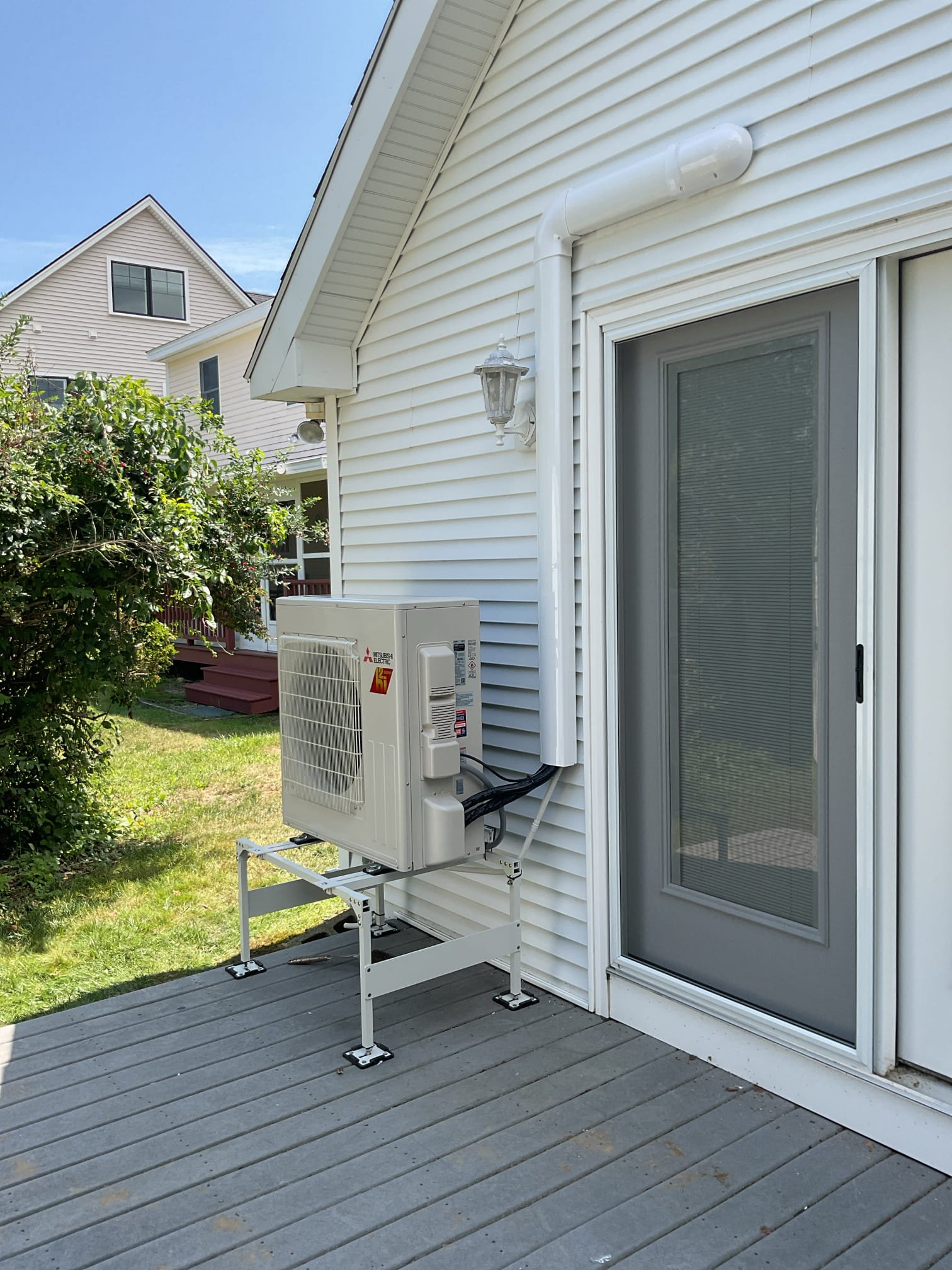 This project is designed to bring top-tier, year-round comfort to the back great room of your summer home. We will be installing a high-efficiency Mitsubishi Hyper Heat single-zone system. This system will provide powerful, whisper-quiet air conditioning during the humid summer months, and reliable, highly efficient heating during the chilly coastal shoulder seasons and winter months.

Scope of Work

1. Indoor Equipment & Placement

Equipment: We will safely mount a brand-new Mitsubishi ductless wall unit in the back great room.

Placement Details: The unit will be mounted high on the wall above the two rear French doors, specifically positioned to the right side of the mounted deer head.

Controls: This unit will be controlled via an intuitive, easy-to-use handheld remote, giving you complete temperature control over the great room space.

2. Outdoor Equipment & Line Set Routing

Hyper Heat Condenser: We will install the new Mitsubishi Hyper Heat outdoor condenser unit.

Placement: Th