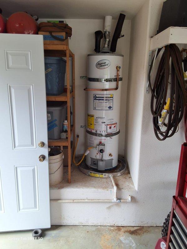 Replaced a 17-year-old leaking 40-gallon propane water heater with a new American Standard 40-gallon propane unit. The installation included connecting the flexible gas line, exhaust venting, water supply lines, and positioning the unit on a drip pan in the utility closet. Permit requirements were discussed with the property owner, and all work was completed to code specifications.
