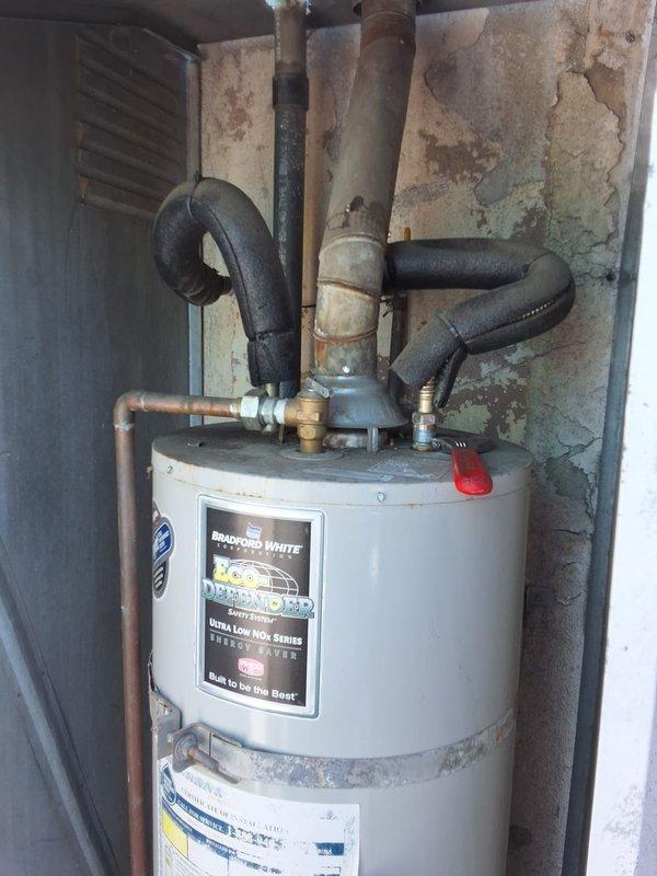 Responded to service call for pilot light repeatedly going out on Bradford White water heater model URG40T6N, serial number TE43448960. Upon arrival, unit was operational with pilot lit. Successfully relit pilot and tested gas control valve and thermocouple operation. Inspection revealed significant environmental concerns affecting unit longevity and safe operation. Water heater enclosure shows extensive moisture damage with deteriorating walls, peeling paint, and water staining throughout utility closet area, indicating inadequate ventilation and possible water intrusion issues. Venting system requires attention to ensure proper combustion air supply and exhaust. Current installation environment compromises equipment performance and contributes to recurring pilot outage issues. Unit is beyond original installation warranty period. Advised customer that while water heater is currently operational, the deteriorated enclosure and inadequate venting must be addressed to prevent continued 