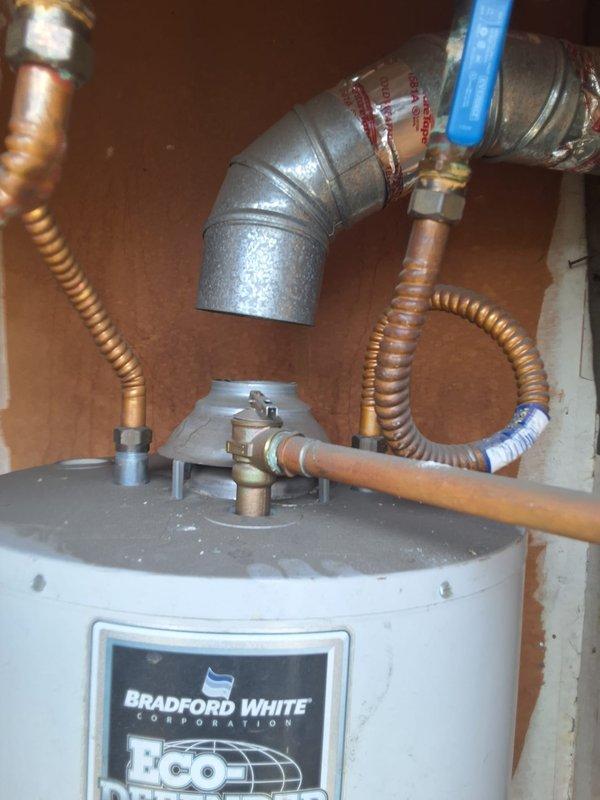 Responded to service call regarding a 7-year-old gas water heater that homeowner believed was previously installed by our company. Upon arrival, inspected Bradford White Corporation model URG140S6N, serial number HE41060, manufactured January 2017, which is a 40-gallon natural gas atmospheric storage water heater with 40,000 BTU/hr input rating. Performed visual inspection of unit and surrounding plumbing connections, including flexible gas supply lines, copper water piping, shutoff valves, and temperature/pressure relief valve discharge piping. Documented existing installation with photographs showing overall unit condition, manufacturer data plate specifications, and current piping configuration. Verified unit specifications and installation details, then provided homeowner with assessment and recommendations for next steps.