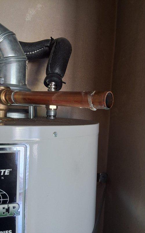 Responded to service call for leaking temperature and pressure relief valve on Bradford White water heater model URG140T6N. Upon arrival, found that homeowner had purchased and attempted to install replacement T&P valve but was unable to remove existing valve due to improper installation technique. Assessed the situation and successfully removed the improperly seated T&P valve using appropriate tools and procedures. Installed new temperature and pressure relief valve with proper thread sealant, torqued to manufacturer specifications, and verified proper seating and alignment. Tested T&P valve operation and confirmed no leaks at connection point. Unit returned to normal operation with all safety devices functioning correctly.