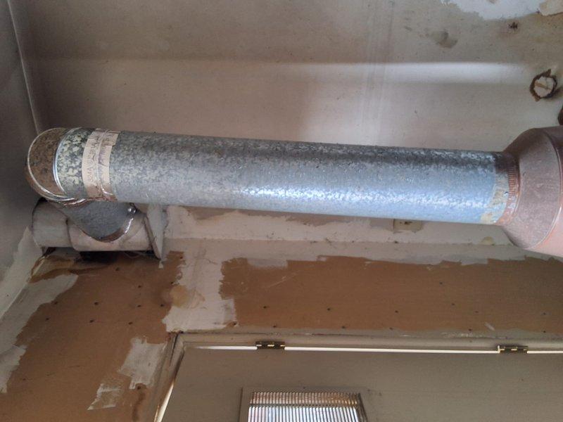 Conducted commercial site assessment for multi-unit residential property experiencing water heater system failure. Existing boiler system serving 12 individual units (one bathroom each) exhibited active leaking with visible water damage to surrounding walls and condensation on distribution piping. Documented current equipment configuration including deteriorated piping infrastructure, valve assemblies, and cylindrical storage component showing significant age-related wear. Provided estimate for complete system replacement, transitioning from boiler configuration to conventional tank-style water heating system to meet property requirements and restore hot water service to all units.