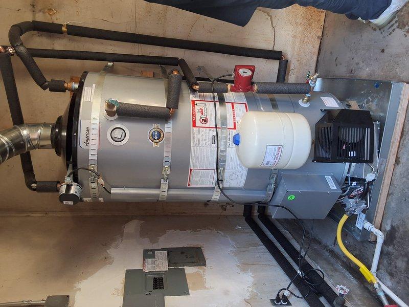 Completed commercial boiler and storage tank replacement serving 12 residential units. Removed existing water heating system and installed new UCG100H2703N boiler unit with associated storage tank, expansion tank, and all necessary components. Connected black insulated supply and return piping with brass fittings and pressure relief valves. Installed metallic flex duct venting system with PVC connections for proper exhaust ventilation. Mounted circulation pump with electrical connections and wired system to existing electrical panel. Secured equipment with metal strapping and mounted on appropriate base platforms per code requirements. System tested for proper operation, pressure levels verified, and all connections inspected for leaks. Permitting requirements reviewed and approved prior to installation.