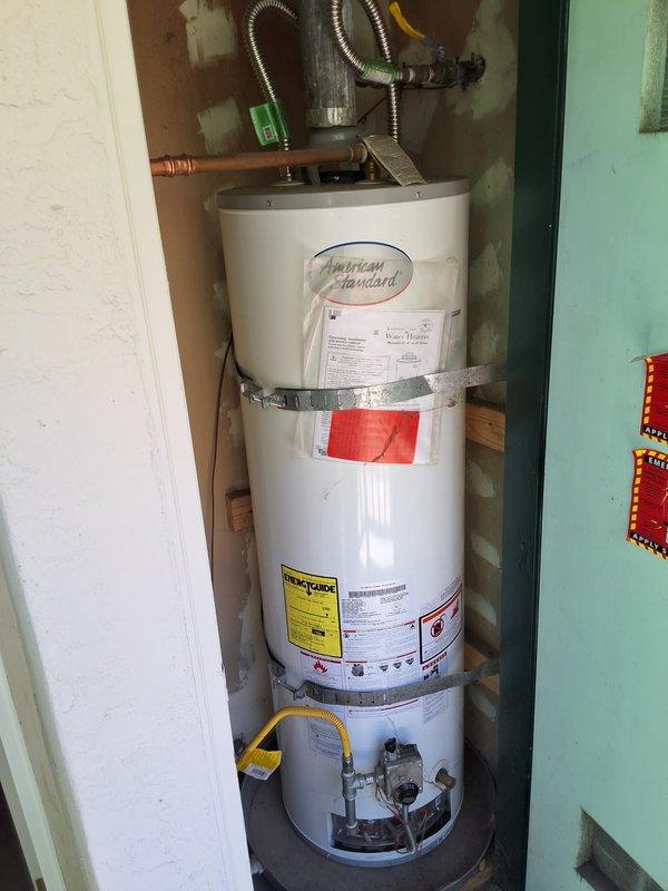 Responded to no hot water complaint at property management account. Upon arrival, inspected American Standard gas water heater model GN40T1 installed in utility closet. Performed diagnostic evaluation of unit including visual inspection of gas control valve, burner assembly, pilot light, thermocouple, and all plumbing connections. Checked gas supply line, pressure relief valve, and verified proper venting. Documented equipment condition with photographs showing water heater installation, safety strapping, copper supply lines, flexible gas connector, and all visible components. Contacted office from site with diagnostic findings per property management protocol for pricing approval before proceeding with any repairs.
