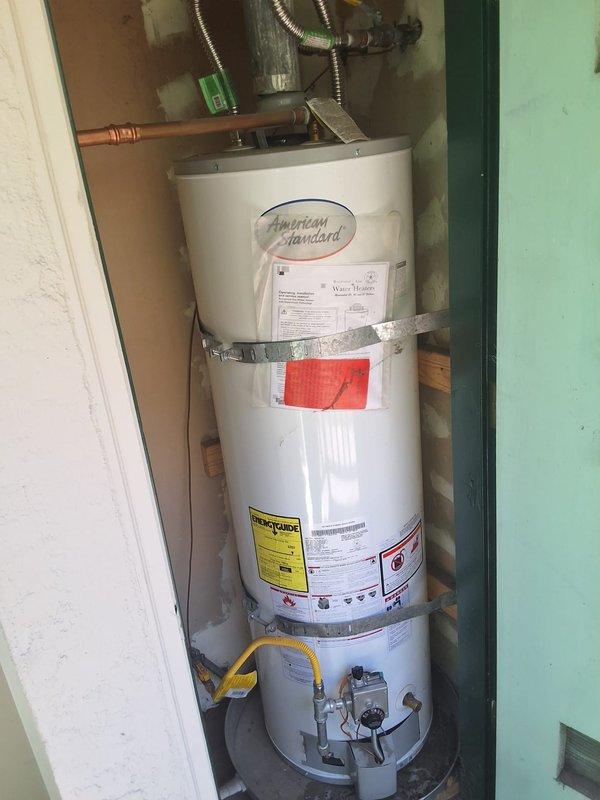 Responded to no hot water complaint at property management account. Upon arrival, inspected American Standard gas water heater model GN40T1 installed in utility closet. Performed diagnostic evaluation of unit including visual inspection of gas control valve, burner assembly, pilot light, thermocouple, and all plumbing connections. Checked gas supply line, pressure relief valve, and verified proper venting. Documented equipment condition with photographs showing water heater installation, safety strapping, copper supply lines, flexible gas connector, and all visible components. Contacted office from site with diagnostic findings per property management protocol for pricing approval before proceeding with any repairs.