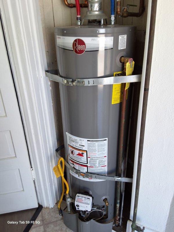 Responded to recurring no hot water complaint at property management unit. Replaced failed 40-gallon gas water heater with new Rheem unit in utility closet, including proper seismic strapping, copper supply line connections with color-coded flexible connectors, and gas valve assembly. Coordinated with property management per protocol before proceeding with tenant communication.