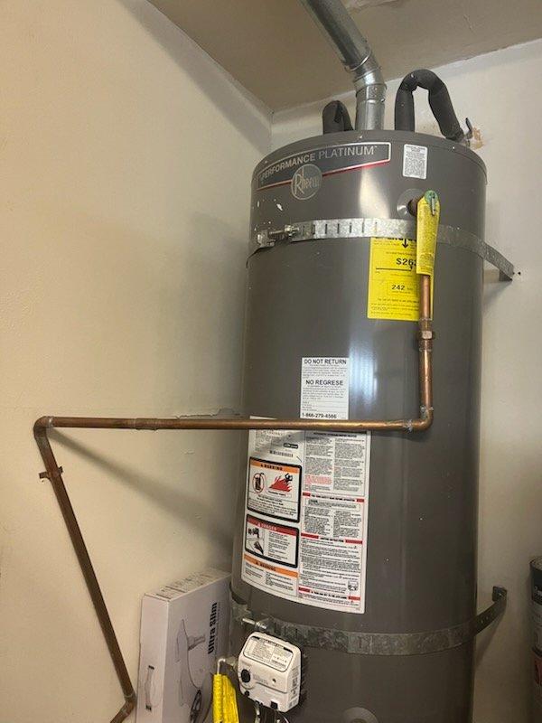 Performed inspection and estimate on existing 50-gallon gas water heater identified for replacement. Current unit is a Rheem Performance Platinum model showing age and wear, with original manufacturer specifications and serial number information unavailable. Evaluated installation location, existing copper supply line connections, gas valve assembly, temperature and pressure relief valve discharge piping, and drain pan configuration. Discussed replacement options with customer, presenting 50-gallon gas water heater as suitable replacement unit. Reviewed permit requirements for water heater replacement and confirmed customer understanding of permitting process. Provided detailed estimate for complete water heater replacement including removal and disposal of existing unit, installation of new 50-gallon gas water heater with code-compliant connections, and discussed available summer promotional pricing and payment options. Documented existing installation with photographs showing current