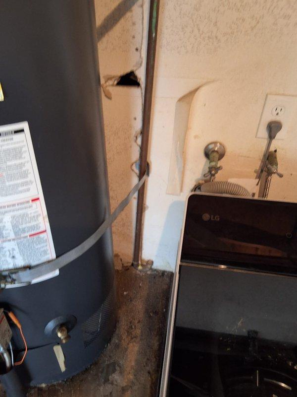 Responded to a leaking 14-year-old 40-gallon gas water heater located in the garage. Removed and disposed of the failed unit (tank information: RHLNM171217209 22V40F) and installed a new 40-gallon gas water heater. Connected all water supply lines, installed flexible gas connector with shutoff valve, verified proper venting, and tested the unit for proper operation and leak-free connections. Documented the installation with photographs showing the completed installation, gas line connections, and drip pan placement. Advised that permitting would be required for this installation.