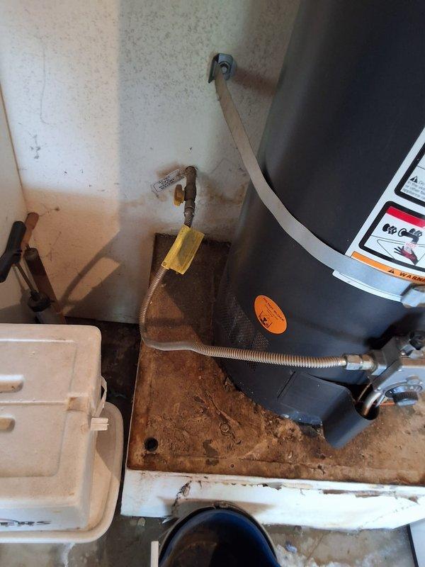 Responded to a leaking 14-year-old 40-gallon gas water heater located in the garage. Removed and disposed of the failed unit (tank information: RHLNM171217209 22V40F) and installed a new 40-gallon gas water heater. Connected all water supply lines, installed flexible gas connector with shutoff valve, verified proper venting, and tested the unit for proper operation and leak-free connections. Documented the installation with photographs showing the completed installation, gas line connections, and drip pan placement. Advised that permitting would be required for this installation.