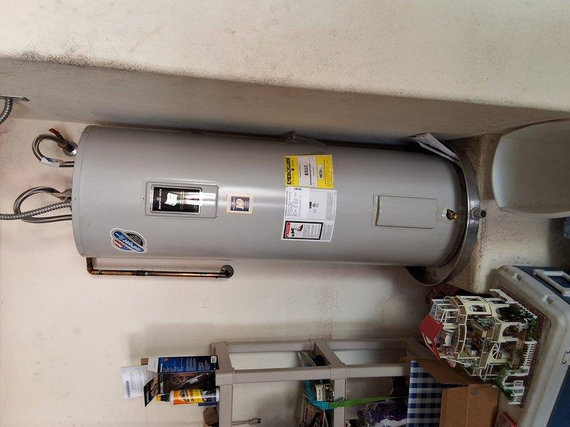 Performed preventive maintenance inspection on 12-year-old 50-gallon electric water heater located in utility area. Evaluated overall condition of unit, including copper piping connections, flexible braided supply lines, and electrical components. Discussed replacement options and provided estimate for installation of new 50-gallon electric water heater model due to age of existing unit approaching end of typical service life. Documented current installation with photographs showing tank condition, plumbing connections, and surrounding clearances. Reviewed available payment methods for future replacement work.