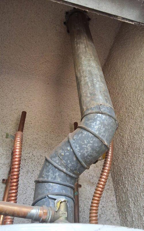 Responded to a water heater leak and replaced a 16-year-old 50-gallon residential water heater. Installed new 50-gallon unit with proper copper supply line connections and exhaust venting through existing ductwork. Customer was advised of permitting requirements and approved the installation.