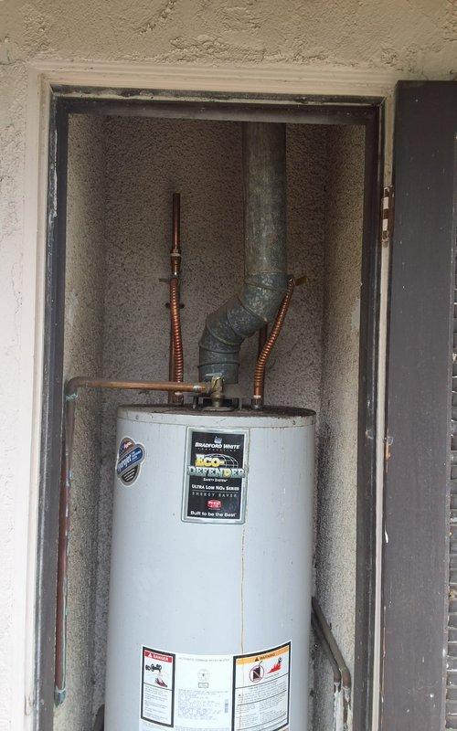 Responded to a water heater leak and replaced a 16-year-old 50-gallon residential water heater. Installed new 50-gallon unit with proper copper supply line connections and exhaust venting through existing ductwork. Customer was advised of permitting requirements and approved the installation.