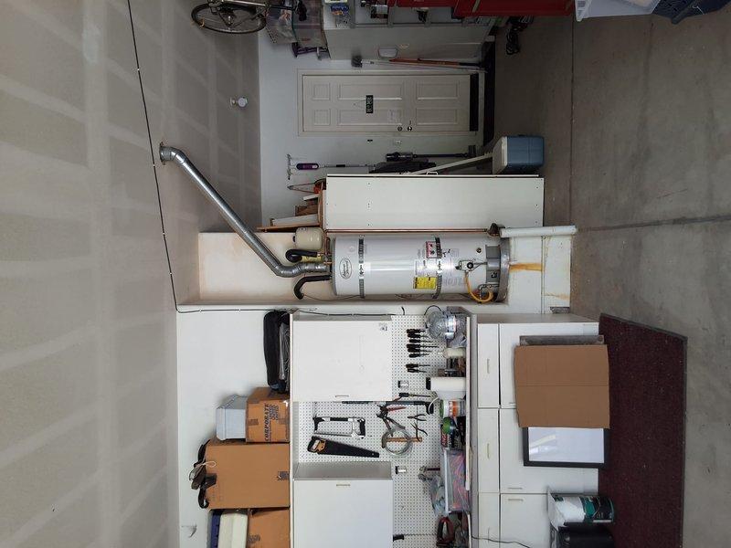 Responded to service call for dripping temperature and pressure relief valve on 12-year-old Bradford White U1-75S6N water heater. After assessment, customer elected to proceed with full unit replacement rather than repair. Successfully installed new 50-gallon gas water heater model LGN50T1-3-6 in garage utility area, including proper venting, gas line connections, and mounting hardware. All work performed in compliance with code requirements and permit obtained as required.