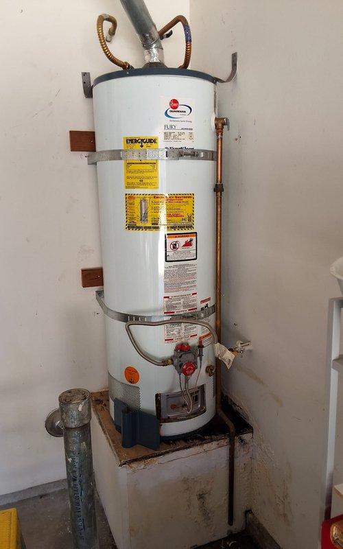 Replaced failed 2006 50-gallon gas water heater that was actively leaking. Installed new Rheem Fury Guardian system 50-gallon gas water heater model GN50T1-3-6 with proper venting, copper supply line connections, and code-compliant safety features including TPR valve discharge piping. Secured permit and completed installation per local plumbing codes and manufacturer specifications.