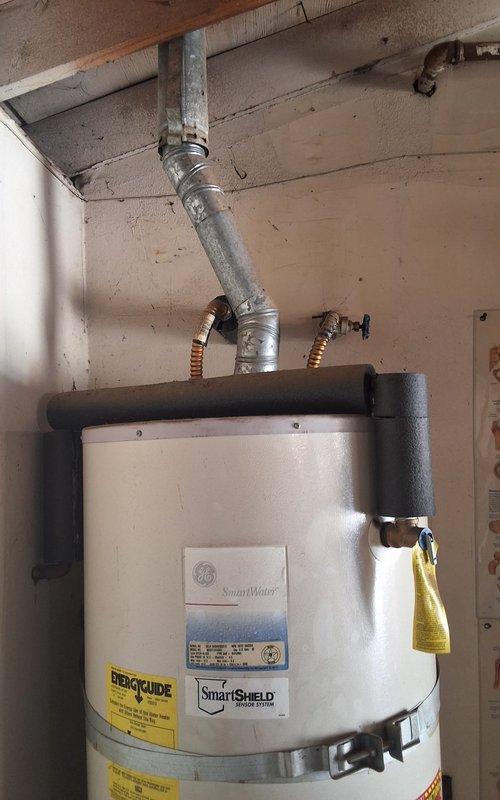 Provided estimate for replacement of existing 2007 50-gallon gas water heater currently located in garage. Offered GN50T1-3 model 50-gallon gas water heater as part of summer promotion, with pricing to include necessary code compliance modifications and county permit fees. Customer advised of county permitting requirements and associated costs. Scheduled installation appointment with arrival window confirmed for Saturday morning between 9:00 AM and 12:00 PM. Documented existing water heater installation with photographs showing current unit condition, venting configuration, and installation location for reference during replacement work.