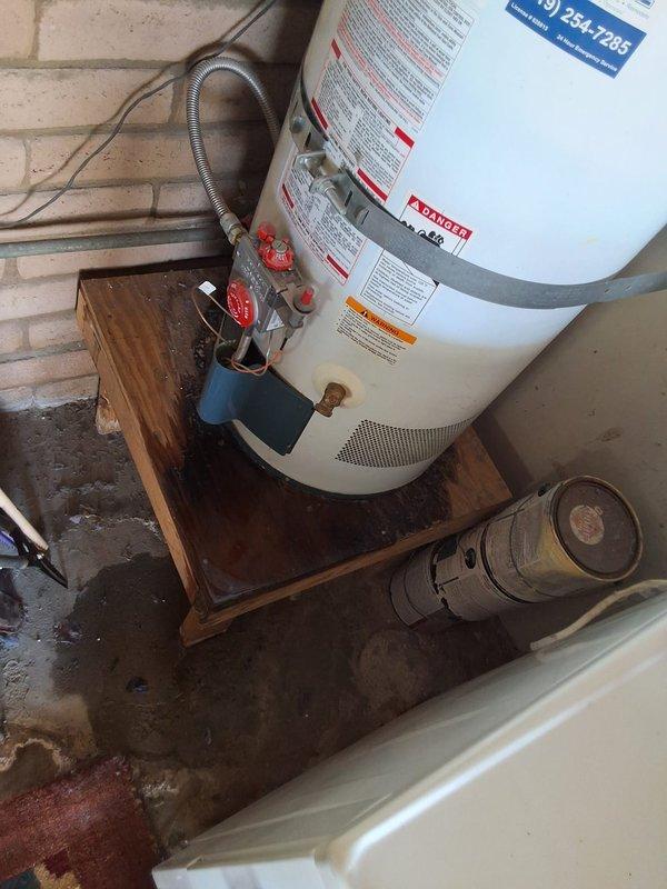 Responded to service call for leaking residential gas water heater. Upon inspection, found approximately 20-year-old 40-gallon gas unit with active leak and severe corrosion on inlet/outlet connections and fittings. Removed and disposed of failed water heater. Installed new 40-gallon residential gas water heater on existing wooden platform, connected all supply and discharge lines, installed new pressure relief valve with discharge piping, and tested all connections for proper operation and leak-free performance. Advised customer of permit requirements and provided pricing estimate range for complete replacement. Unit operational and system functioning properly upon departure.