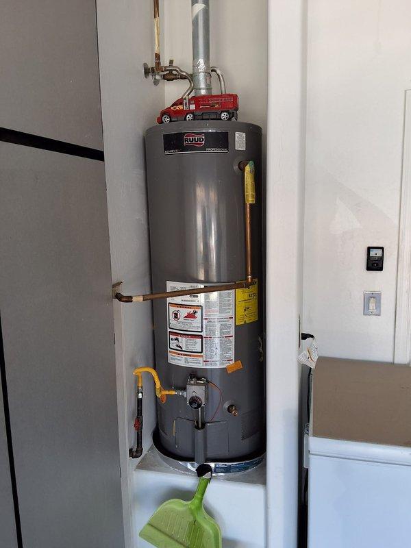 Responded to service call for leaking 50-gallon gas water heater (model PROG50-38NUR) located in garage. Upon arrival within scheduled 8-11:00 AM window, confirmed active leak requiring immediate replacement. Removed and disposed of failed unit. Installed new 50-gallon gas Bradford White water heater as part of summer special promotion. Connected all water supply lines with copper piping, installed pressure relief valve with proper discharge piping, and attached yellow-handled shut-off valves at base connections. Tested all connections for leaks, verified proper gas line connections, and ensured unit operational functionality. Installation completed in residential utility closet space with all plumbing connections secured and system restored to full working order.