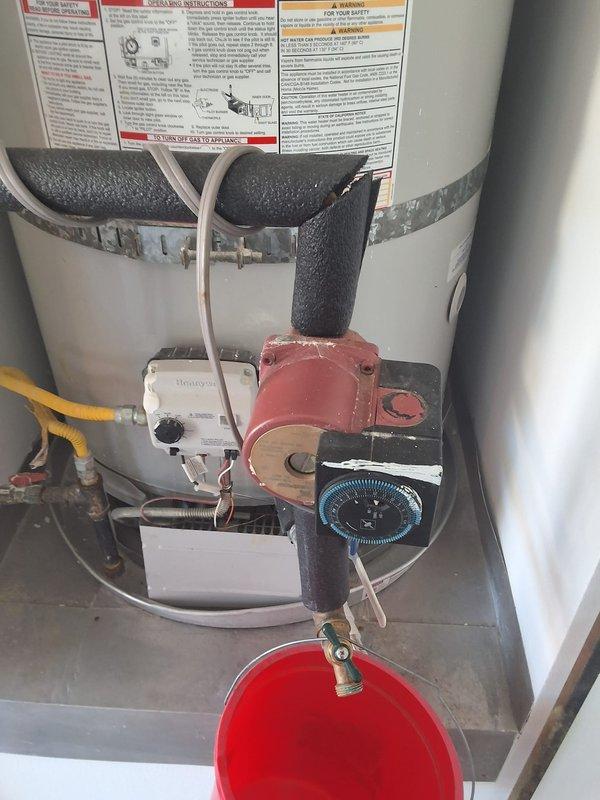 Performed inspection and estimate on 5-year-old Bradford White 75-gallon gas water heater, model URG275H6N, serial WB44607100. Customer requested evaluation for installation of hot water recirculation pump system. Documented existing plumbing configuration, photographed current setup including gas control valve, piping connections, and available mounting locations for pump integration.