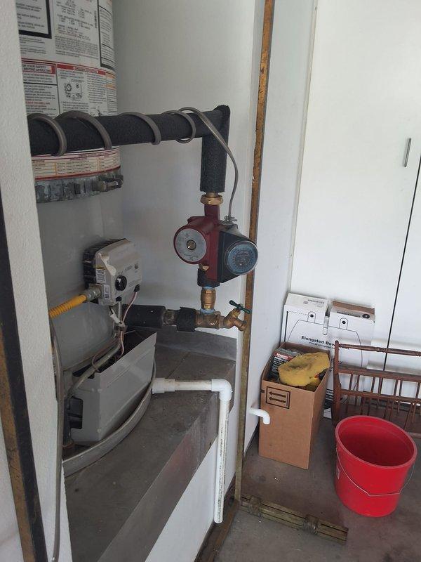 Performed inspection and estimate on 5-year-old Bradford White 75-gallon gas water heater, model URG275H6N, serial WB44607100. Customer requested evaluation for installation of hot water recirculation pump system. Documented existing plumbing configuration, photographed current setup including gas control valve, piping connections, and available mounting locations for pump integration.