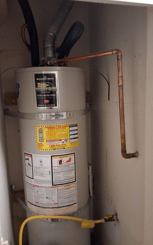 Replaced aging 40-gallon Bradford White natural gas water heater (model NM1503SL27G) that was experiencing rumbling and nearing end of service life. Removed existing unit from interior closet location and installed new Bradford White 40-gallon atmospheric vent gas water heater with proper venting, gas line connection via flexible connector, and copper water line connections. Installation completed per manufacturer specifications and local code requirements with permit obtained.