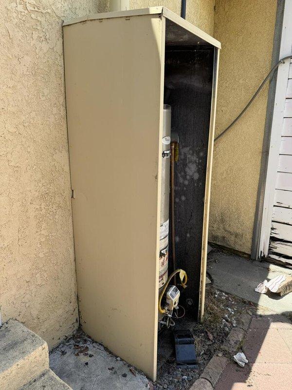 Replaced 2013 Whirlpool NU40T12403 residential water heater due to age and manufacturer recall with new GN40T1-3-6 40-gallon unit installed in exterior utility cabinet enclosure. Removed and disposed of existing tank, installed replacement unit with proper connections to existing plumbing and gas lines, and verified all safety controls and temperature pressure relief valve operation. Customer to obtain permit separately for installation compliance.