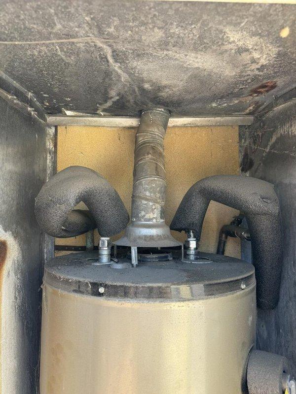 Replaced 2013 Whirlpool NU40T12403 residential water heater due to age and manufacturer recall with new GN40T1-3-6 40-gallon unit installed in exterior utility cabinet enclosure. Removed and disposed of existing tank, installed replacement unit with proper connections to existing plumbing and gas lines, and verified all safety controls and temperature pressure relief valve operation. Customer to obtain permit separately for installation compliance.