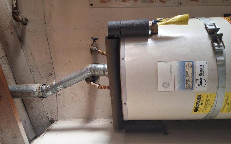 Completed conversion installation from 50-gallon atmospheric gas tank water heater (Model SG50T12AVG00, Serial GELN0404V00313) to tankless system. Installed Navien NPE-210A2 tankless water heater unit in garage/patio location per approved estimate and signed permit documentation. Removed existing tank-style water heater and reconfigured gas line, water supply lines, and venting system to accommodate tankless unit specifications. Installed required pressure relief valve, isolation valves, and proper condensate drainage. Secured all plumbing connections with appropriate fittings and verified gas line integrity. Tested unit operation, adjusted temperature settings, and confirmed proper ignition sequence and water flow. Completed full-day installation with all safety protocols observed and system fully operational upon departure.