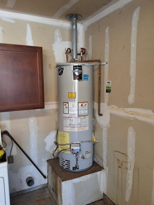 Completed preventative replacement of residential gas water heater with 40-gallon unit, model M440T6FBN. Installed water heater on wooden platform in utility room with proper seismic strapping to wall, connected copper supply lines and gas line, installed temperature/pressure relief valve with discharge piping, and vented unit through ceiling per manufacturer specifications. Customer advised that permitting is their responsibility to complete.