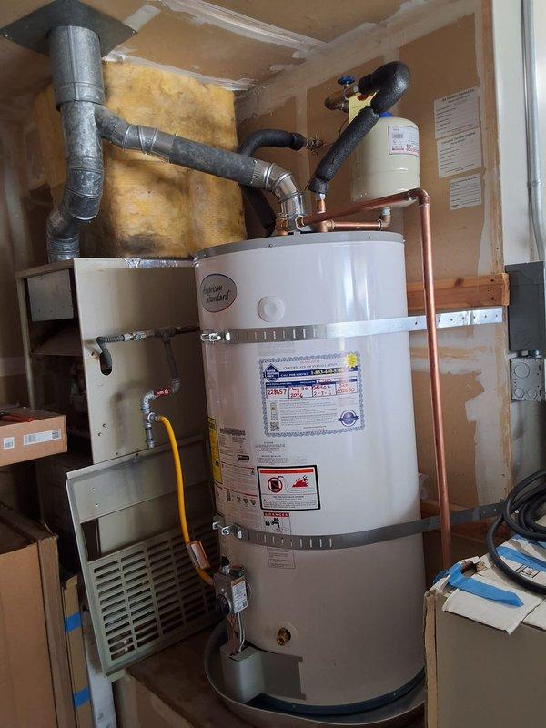 Responded to warranty callback for gas odor complaint on water heater model GN50L-2-3-6. Tightened T-coupling connection on gas line to eliminate leak. Verified all gas connections secure and system operating safely per manufacturer specifications.