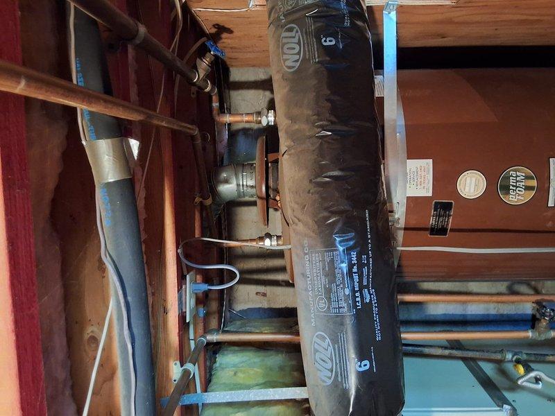 Responded to service call for leaking water heater in basement. Inspected existing 100-gallon gas water heater and documented current installation with photographs showing unit, piping configuration, and mechanical room layout. Discussed replacement options including 50-gallon gas, 50-gallon electric, and tankless gas systems. Provided customer with information regarding permit requirements for water heater replacement and presented ballpark estimates for tankless installation.