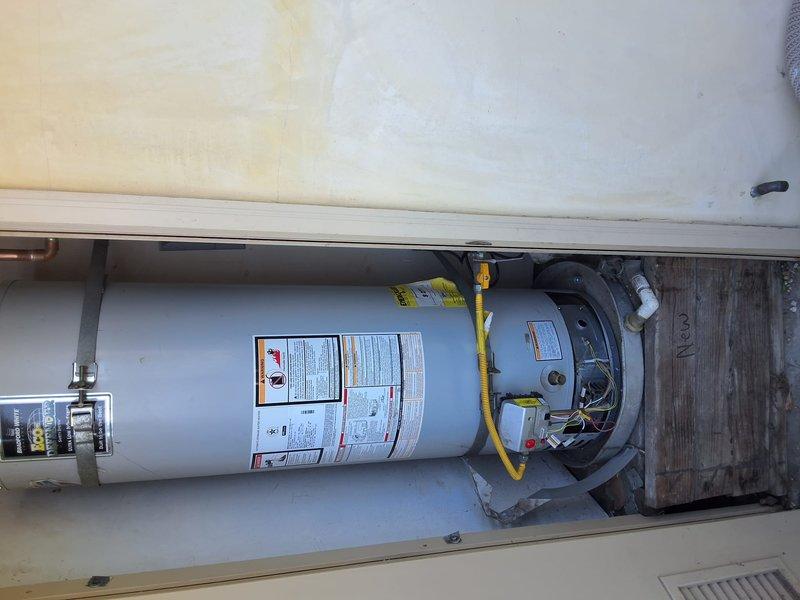 Replaced aging 40-gallon gas water heater from 2014 with new 40-gallon gas unit in residential utility closet. Disconnected and removed old water heater, installed new unit with proper venting and yellow flexible gas line connection, connected water supply lines, and tested system for proper operation. Discussed permit requirements with homeowner and confirmed all installation met code compliance standards.
