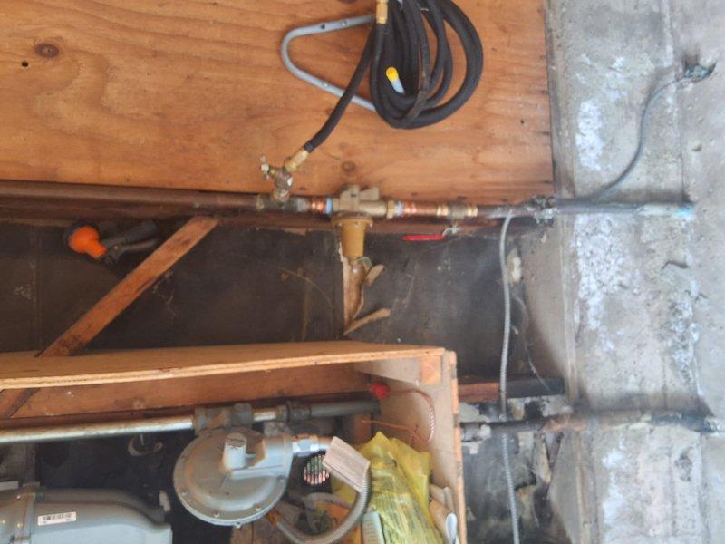 Completed preventative replacement of residential gas water heater with new 40-gallon unit in basement utility area. Removed existing water heater and installed replacement unit with proper copper piping connections, pressure relief valve assembly, temperature and pressure safety devices, and secure mounting with metal strapping. Connected all water supply lines, gas line, and drainage components per code requirements. Obtained necessary permit as requested and ensured all installations met local building and safety standards. Tested unit for proper operation, verified all connections for leaks, and confirmed adequate venting. System operational and ready for service.