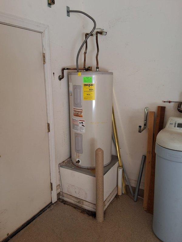 Replaced existing residential water heater in garage with new RE350S6 50-gallon electric unit mounted on elevated platform to meet current code requirements for vacant home sale. Installed new flexible water supply connections, verified proper electrical hookup, and ensured all plumbing connections were secure and leak-free. Unit tested and operational upon completion with all safety features functioning properly.